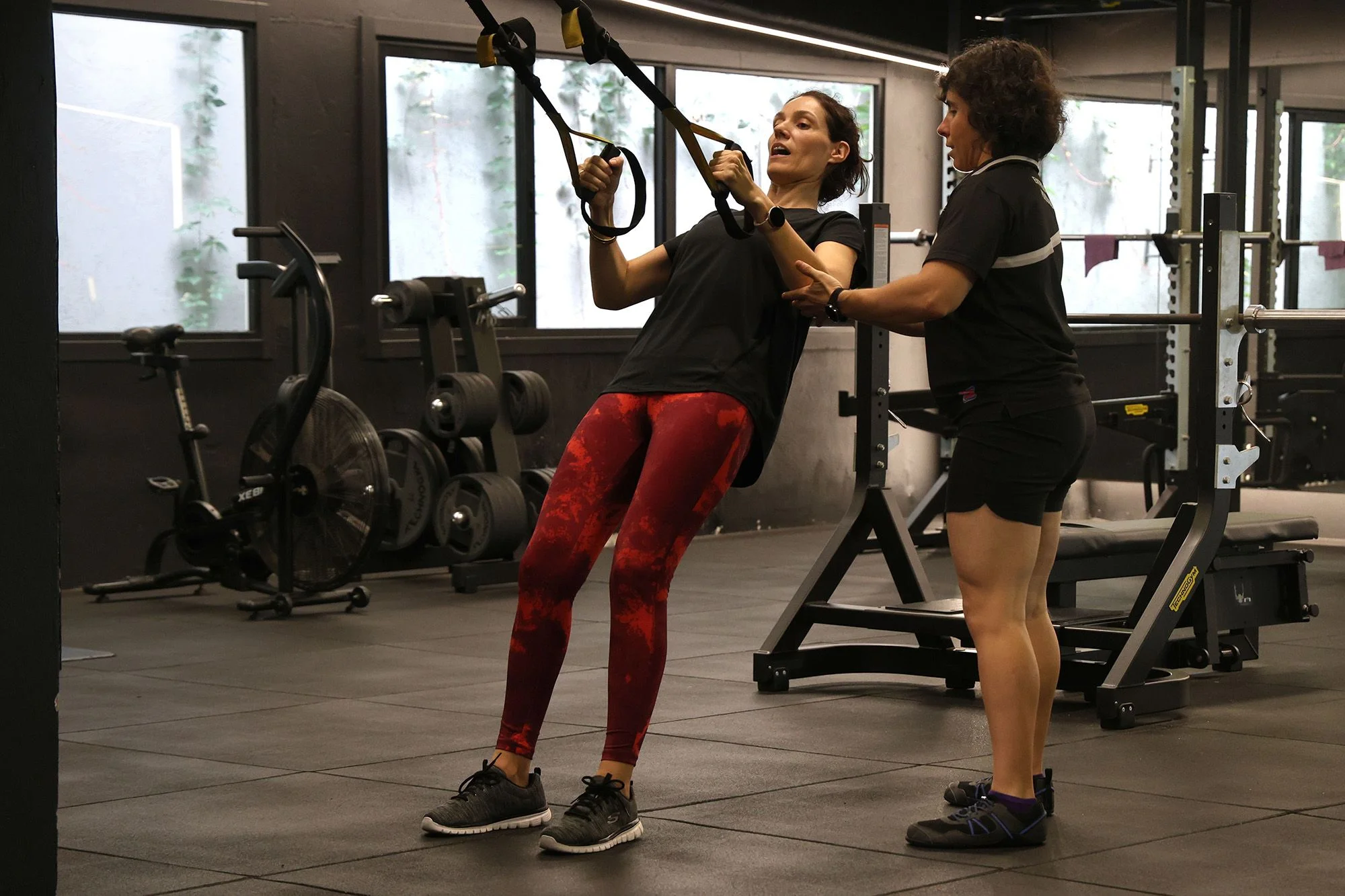 Elena entrenando con clienta en TRX